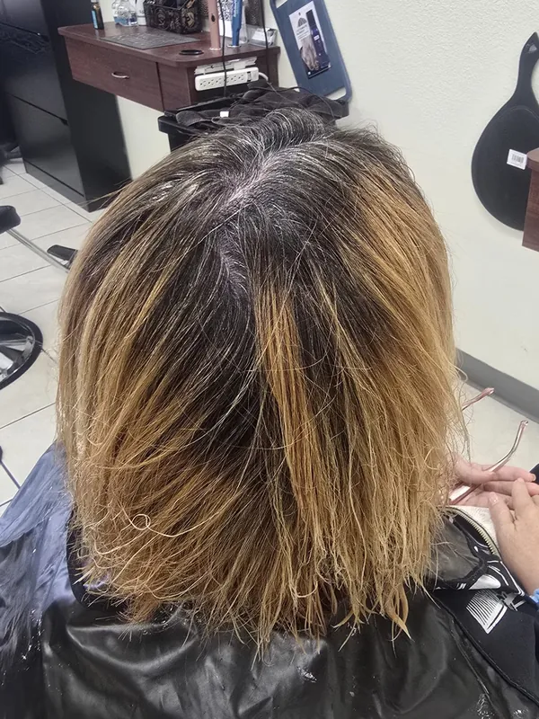 Client hair before color correction, uneven grow-out